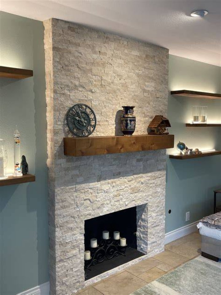 diary stacked in stone fireplace lounge lamps hanging wooden coffee table 