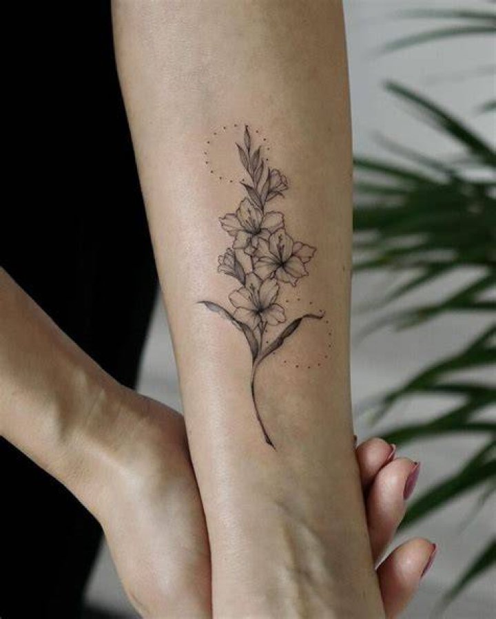 Gladiolus Flower Forearm Tattoo studio87tattoos