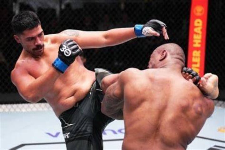 Junior Tafa Pictured Kicking Mohammed Usman During A UFC Fight In April 2023