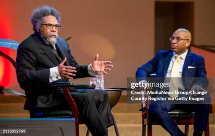 Pastor McBride, left, and Cornel West, right, arrested by officers in Ferguson, Mo during protests over the shooting of Michael Brown.